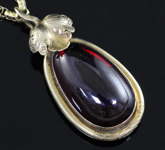A Victorian gold mounted pear shaped cabochon garnet pendant on oval link chain, pendant 35mm.